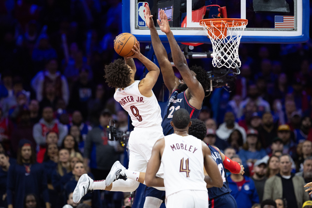 Nov 21, 2023; Philadelphia, Pennsylvania, USA; Cleveland Cavaliers guard Craig Porter (9) drives for a score against Philadelphia 76ers center Joel Embiid (21) during overtime at Wells Fargo Center.